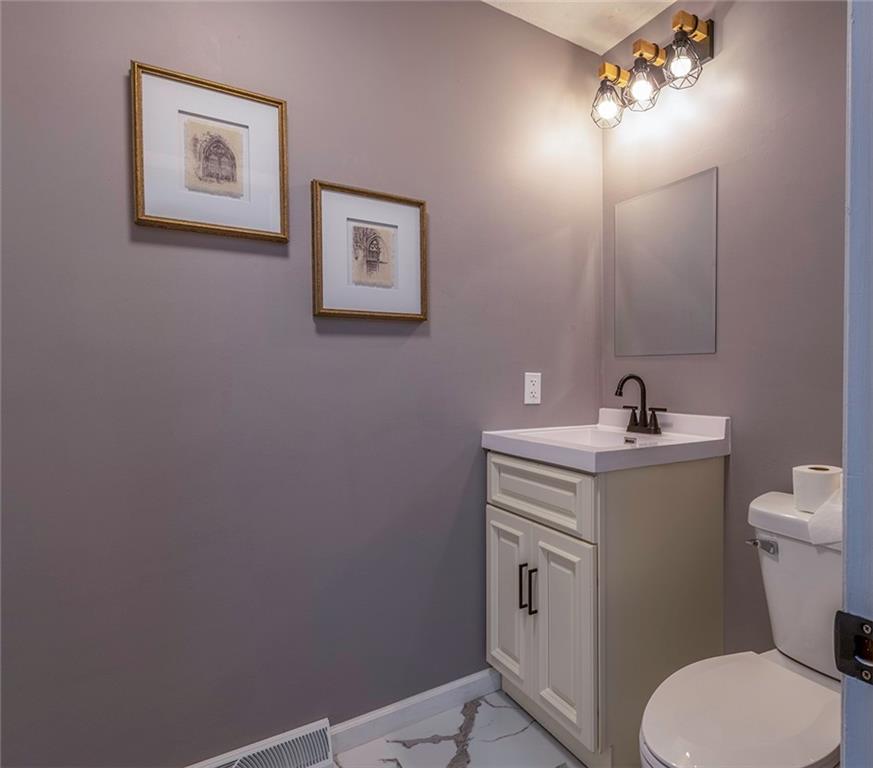 25 Maple Road Greenville, PA 16125 - Photo 9 of 14 a bathroom with a toilet sink and mirror