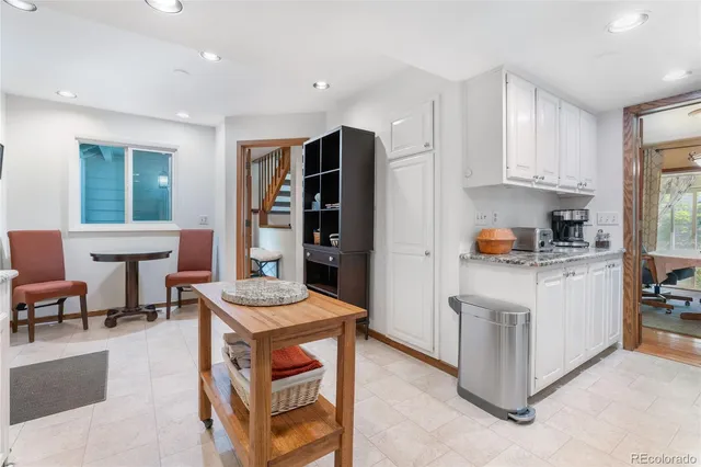 a kitchen with stainless steel appliances granite countertop a stove and a refrigerator