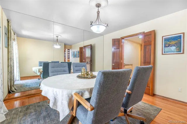 a view of a dining room with furniture wooden floor and chandelier