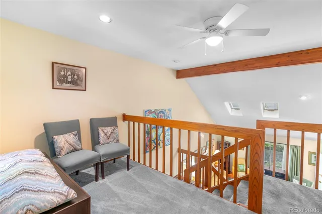 a living room with furniture and a ceiling fan