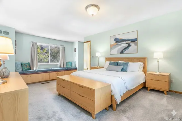 a bedroom with a bed and a couch