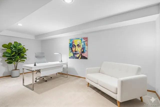 a living room with furniture and a potted plant