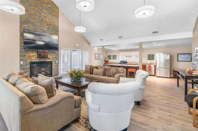 a living room with fireplace furniture and a wooden floor