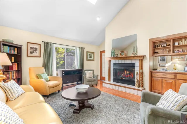 a living room with furniture a table and a fireplace