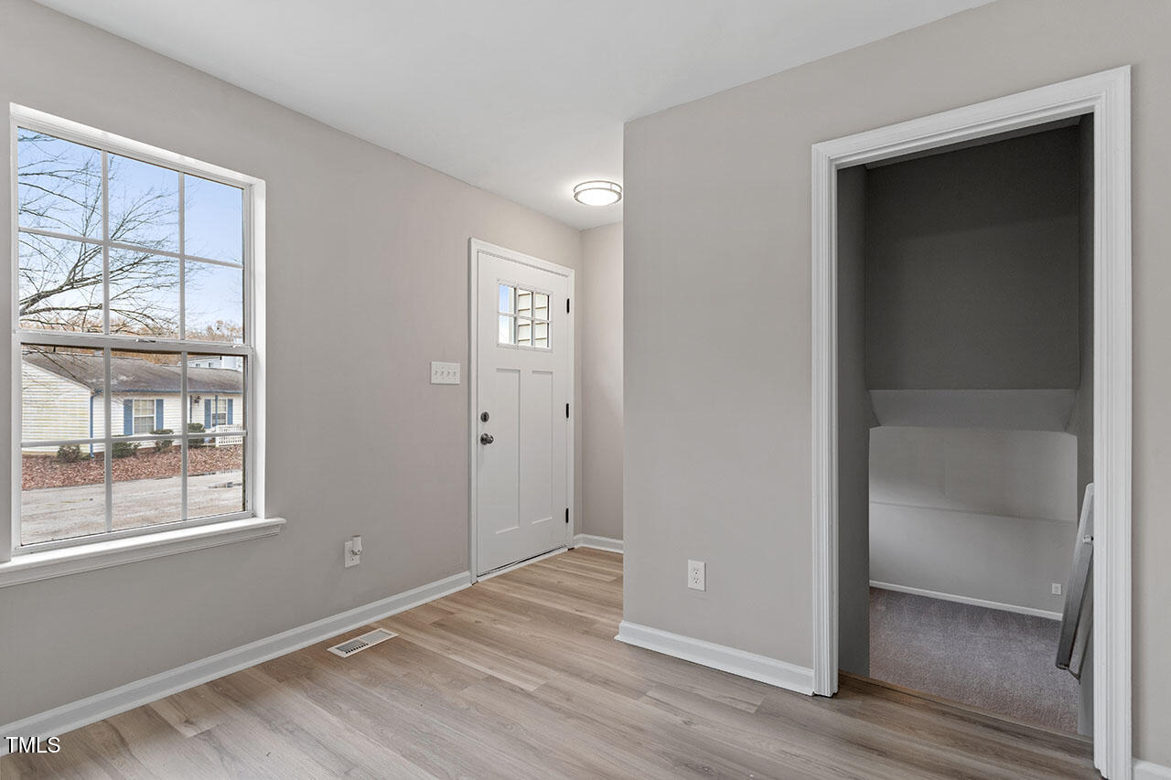 8341 Wynewood Court Raleigh, NC 27616 - Photo 15 of 35 an empty room with wooden floor closet and windows