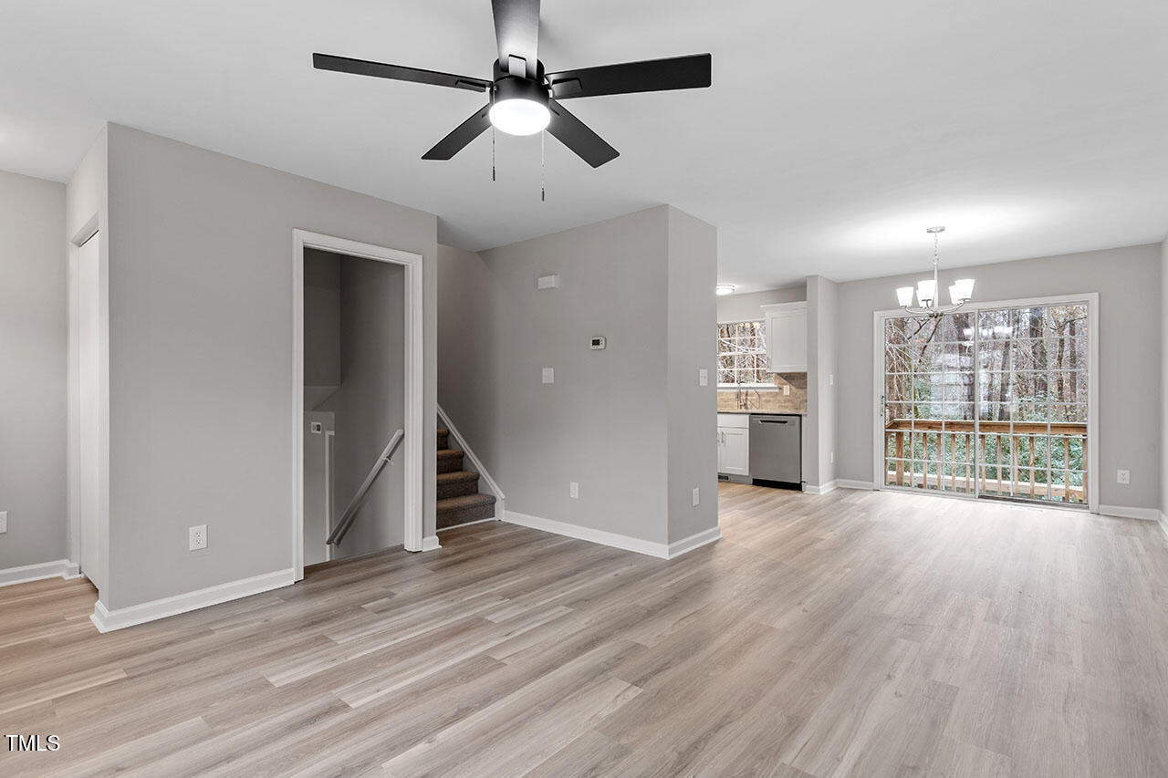 8341 Wynewood Court Raleigh, NC 27616 - Photo 16 of 35 a view of empty room with wooden floor and fan