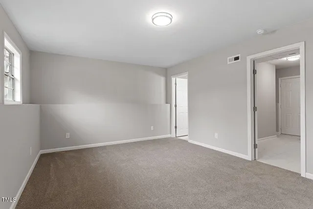 an empty room with windows and closet