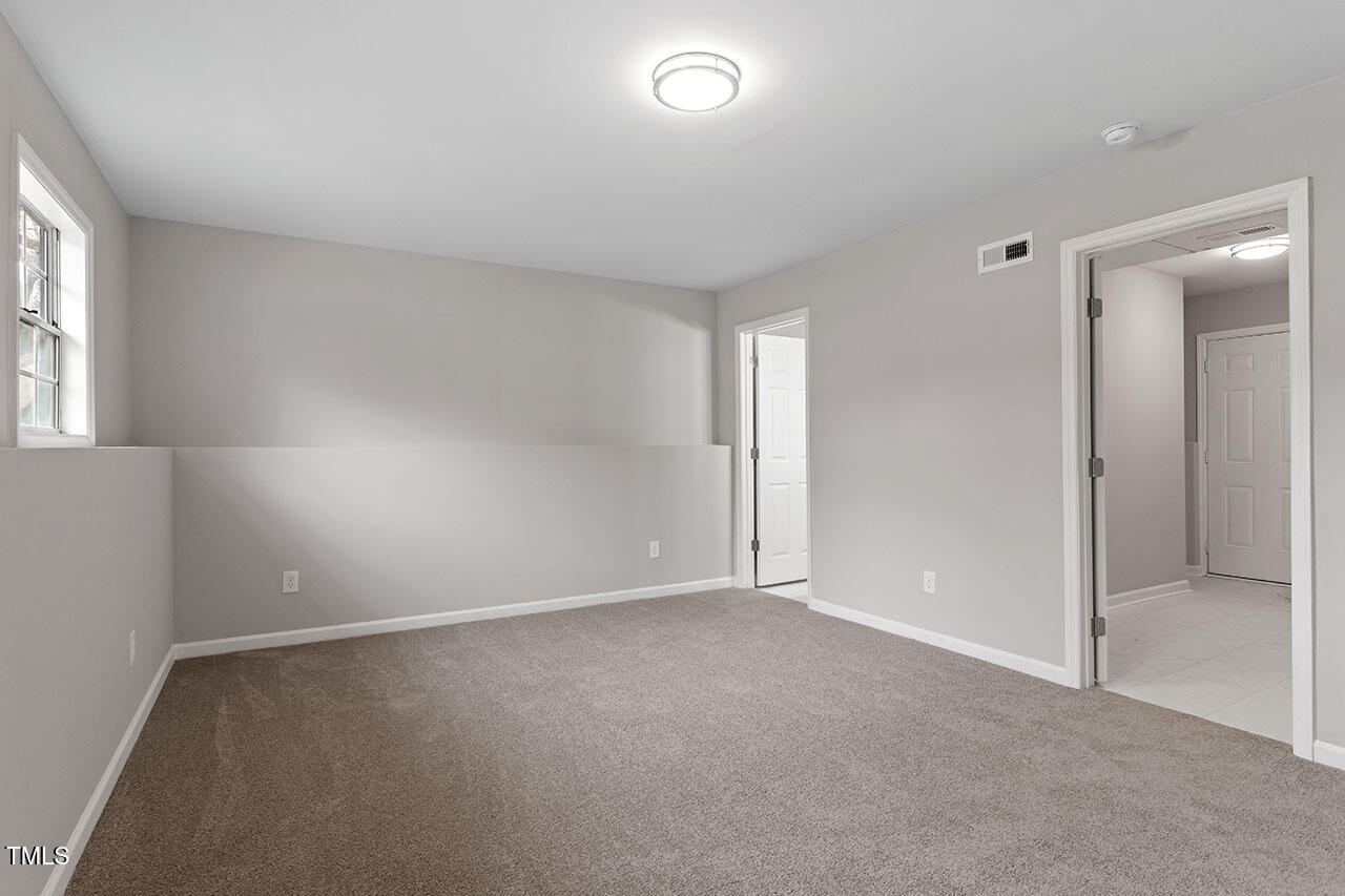 8341 Wynewood Court Raleigh, NC 27616 - Photo 24 of 35 an empty room with windows and closet