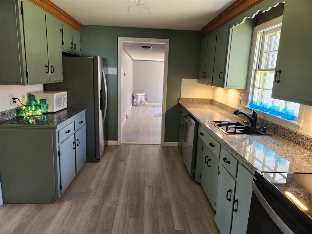 21 Spaulding Road Chelmsford, MA 01824 - Photo 13 of 40 a kitchen with stainless steel appliances granite countertop a refrigerator a stove and a wooden floors