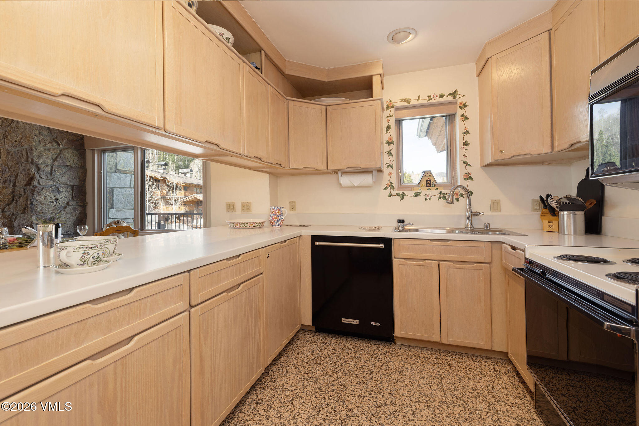 200 Vail Road, Unit 799 Vail, CO 81657 - Photo 9 of 32 a kitchen with a sink and cabinets