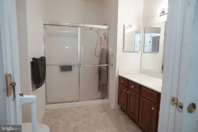 a bathroom with a shower and a sink