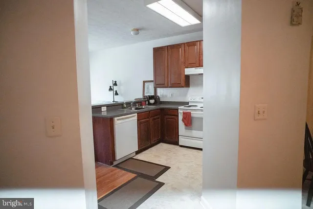 a kitchen with a stove top oven sink and cabinets