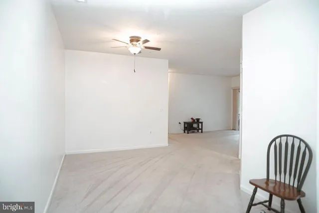 a view of a room with a dining table and chairs