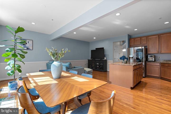 1556 Penzance Way Hanover, MD 21076 - Photo 11 of 40 a dining room with furniture a potted plant and kitchen view