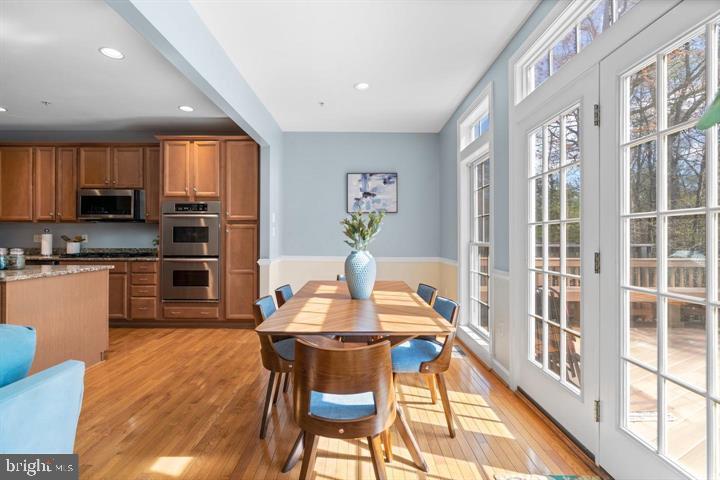 1556 Penzance Way Hanover, MD 21076 - Photo 15 of 40 a kitchen with stainless steel appliances kitchen island granite countertop a refrigerator a stove a sink dishwasher with a dining table and chairs