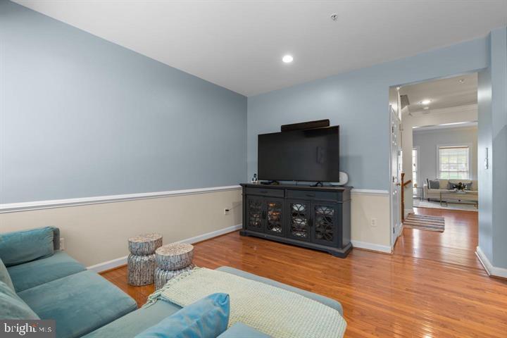 1556 Penzance Way Hanover, MD 21076 - Photo 16 of 40 a living room with furniture and a flat screen tv