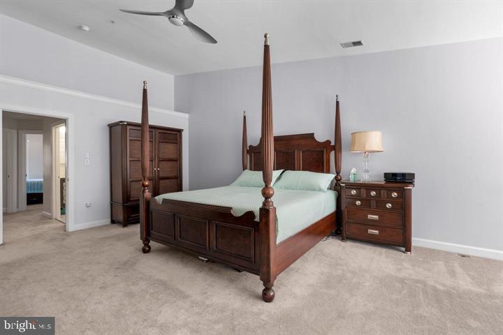 1556 Penzance Way Hanover, MD 21076 - Photo 19 of 40 a spacious bedroom with a bed and a chandelier