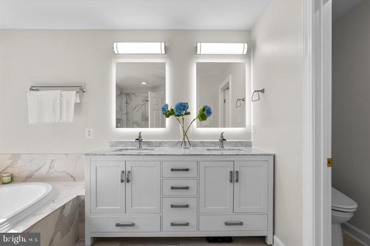 1556 Penzance Way Hanover, MD 21076 - Photo 22 of 40 a bathroom with a granite countertop sink and a mirror
