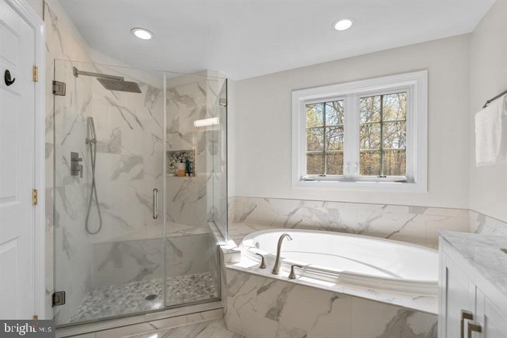 1556 Penzance Way Hanover, MD 21076 - Photo 23 of 40 a bathroom with a tub shower and window