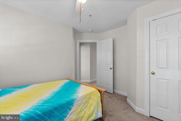 1556 Penzance Way Hanover, MD 21076 - Photo 27 of 40 a bedroom with a bed and a chandelier fan