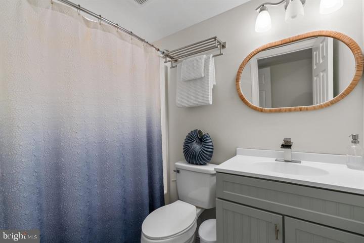 1556 Penzance Way Hanover, MD 21076 - Photo 29 of 40 a bathroom with a toilet a sink and mirror