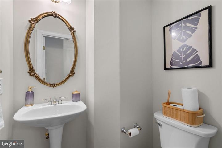 1556 Penzance Way Hanover, MD 21076 - Photo 30 of 40 a bathroom with a toilet sink and mirror