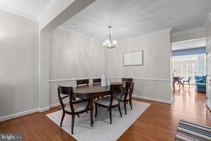 1556 Penzance Way Hanover, MD 21076 - Photo 6 of 40 a view of a dining room with furniture and wooden floor