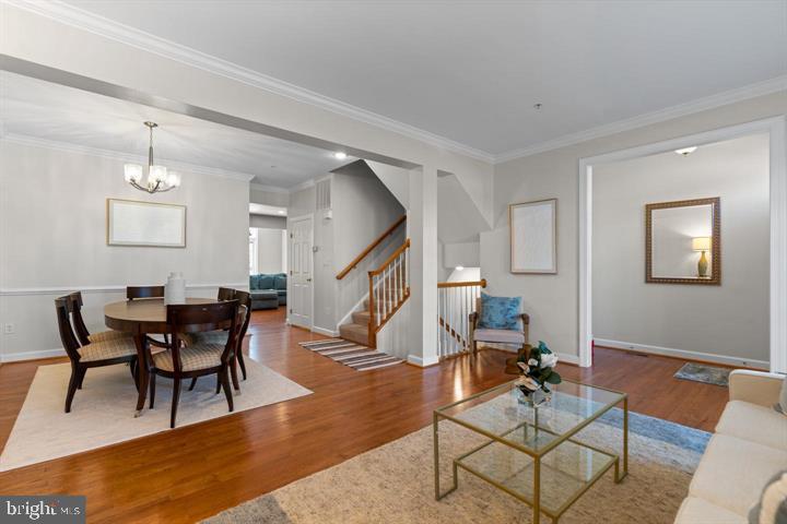 1556 Penzance Way Hanover, MD 21076 - Photo 7 of 40 a living room with furniture and a wooden floor