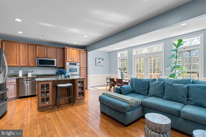 1556 Penzance Way Hanover, MD 21076 - Photo 9 of 40 a living room with furniture and a wooden floor