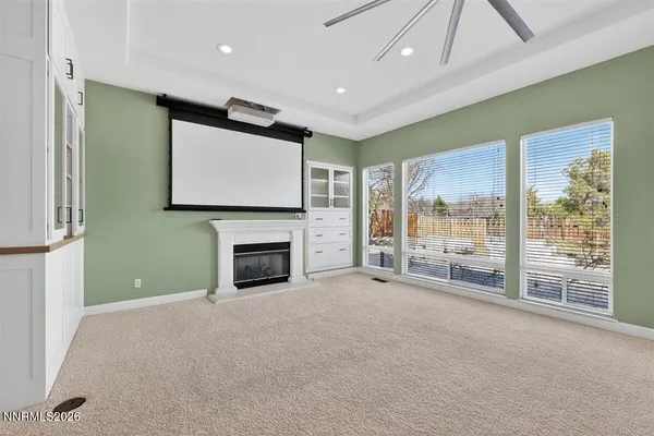 a view of an empty room with a fireplace and a window