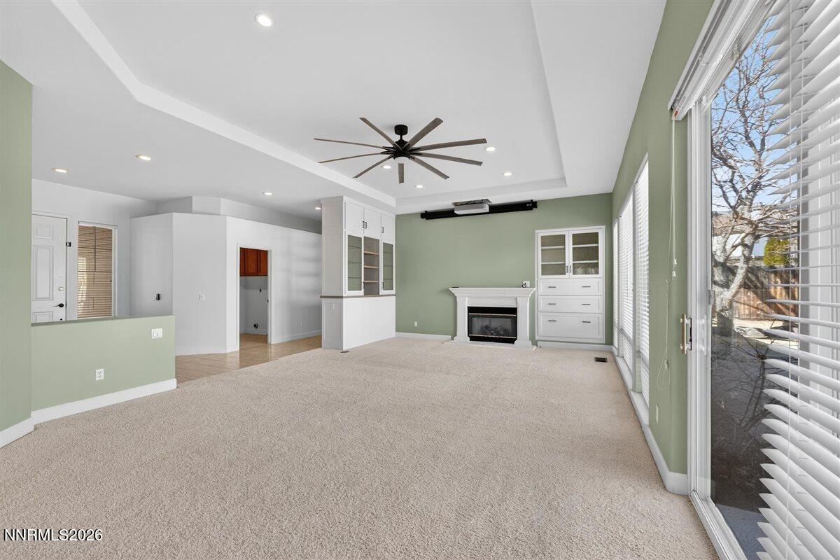2214 St George Way Carson City, NV 89703 - Photo 13 of 57 a view of a livingroom with a kitchen and a ceiling fan