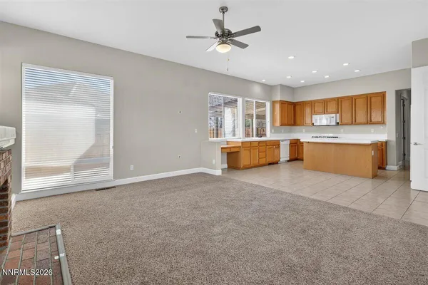 a large kitchen with stainless steel appliances granite countertop a stove a sink and a refrigerator