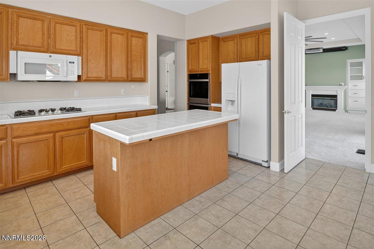 2214 St George Way Carson City, NV 89703 - Photo 23 of 57 a kitchen with stainless steel appliances a refrigerator sink and cabinets