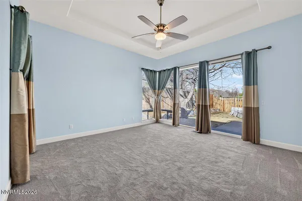 an empty room with fan and entryway