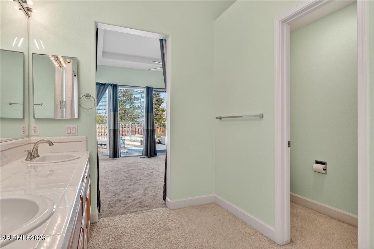 2214 St George Way Carson City, NV 89703 - Photo 28 of 57 a bathroom with a sink and a mirror