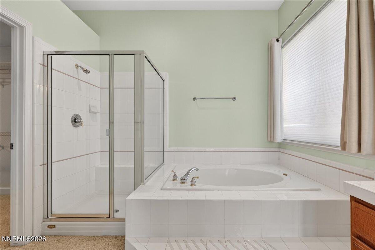 2214 St George Way Carson City, NV 89703 - Photo 30 of 57 a bathroom with a bathtub and a shower