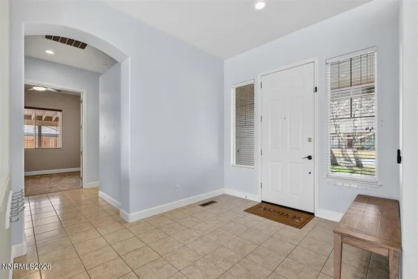 a living room with stainless steel appliances kitchen island granite countertop a refrigerator and a stove top oven