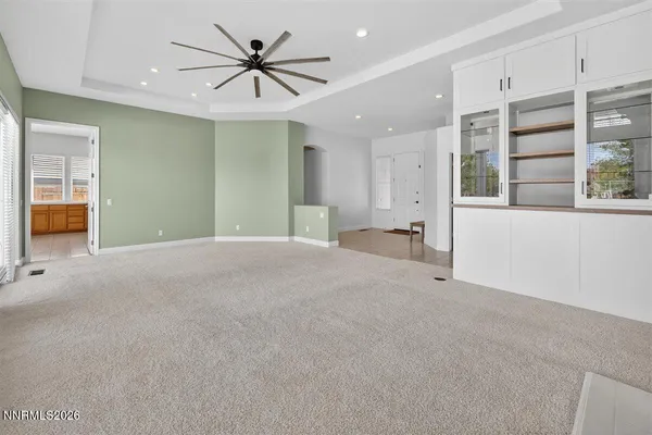 a view of an empty room with a fireplace and a window