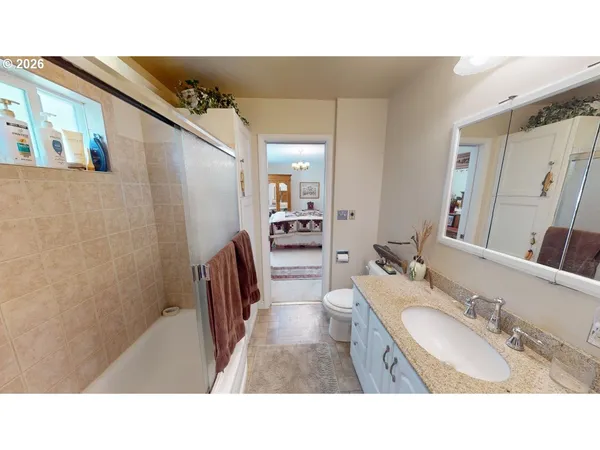 a bathroom with a sink mirror and a bathtub