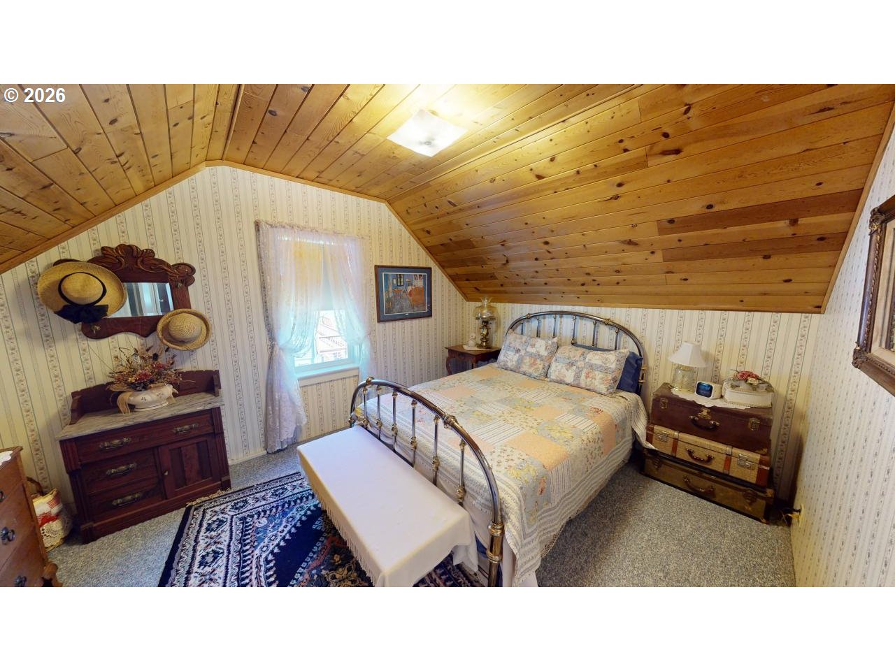 94361 Wedderburn Loop Gold Beach, OR 97444 - Photo 20 of 35 a bedroom with a bed and a dresser