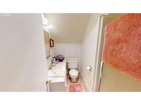 a bathroom with a sink mirror and vanity