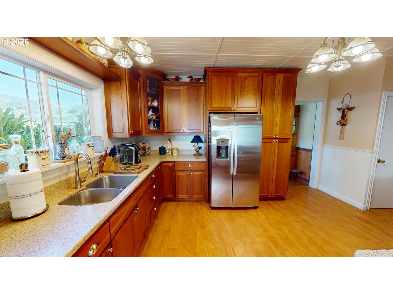 94361 Wedderburn Loop Gold Beach, OR 97444 - Photo 10 of 35 a kitchen with stainless steel appliances granite countertop a refrigerator a sink and wooden cabinets
