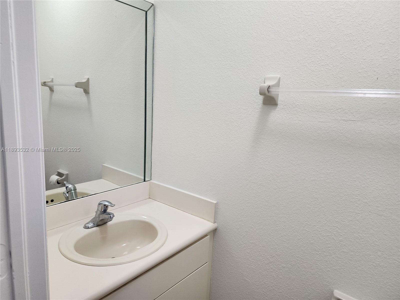10831 Southwest 240th Lane Homestead, FL 33032 - Photo 14 of 33 a bathroom with a sink and a mirror