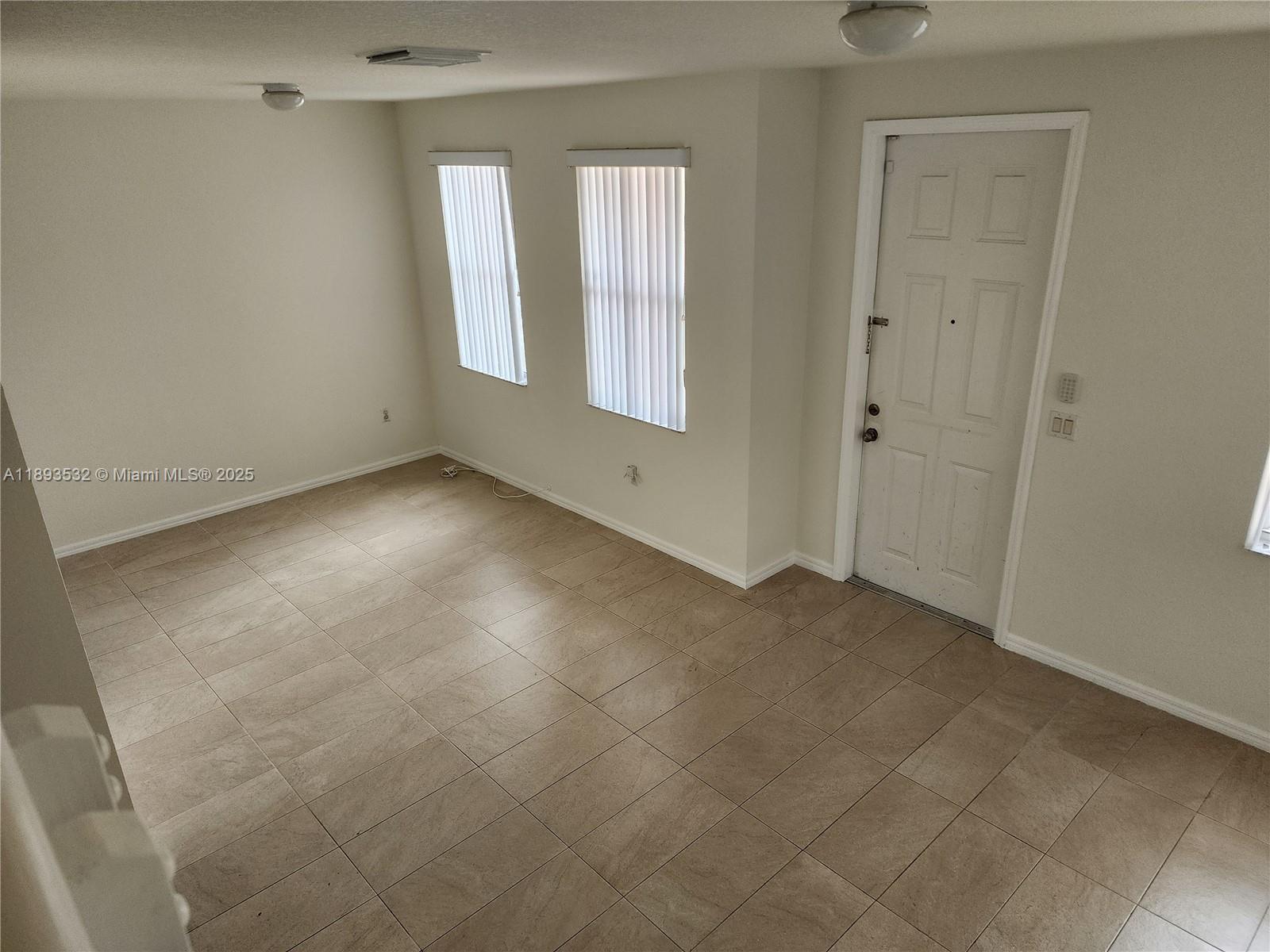 10831 Southwest 240th Lane Homestead, FL 33032 - Photo 17 of 33 an empty room with windows