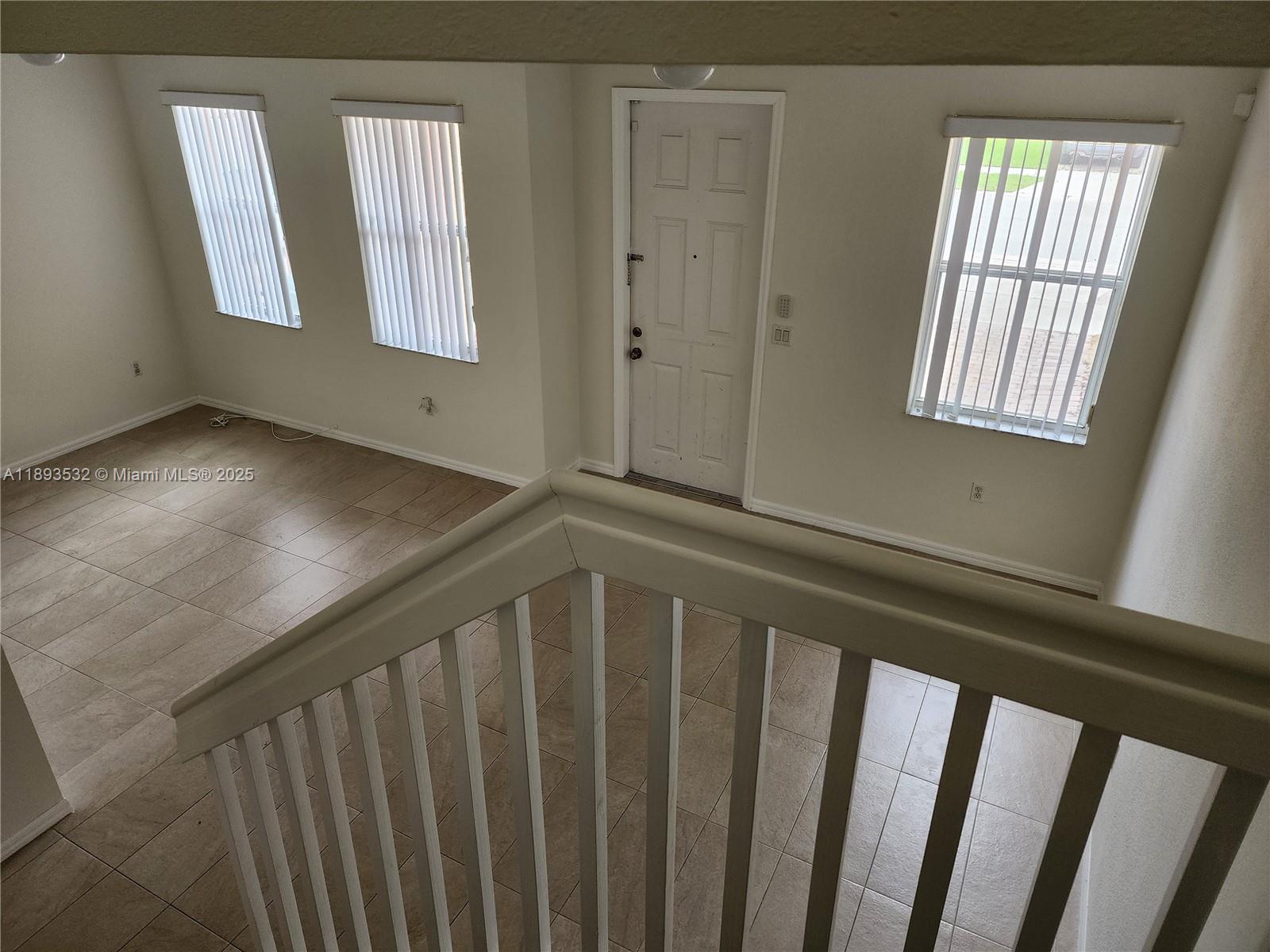 10831 Southwest 240th Lane Homestead, FL 33032 - Photo 18 of 33 a view of wooden floor and windows in a room