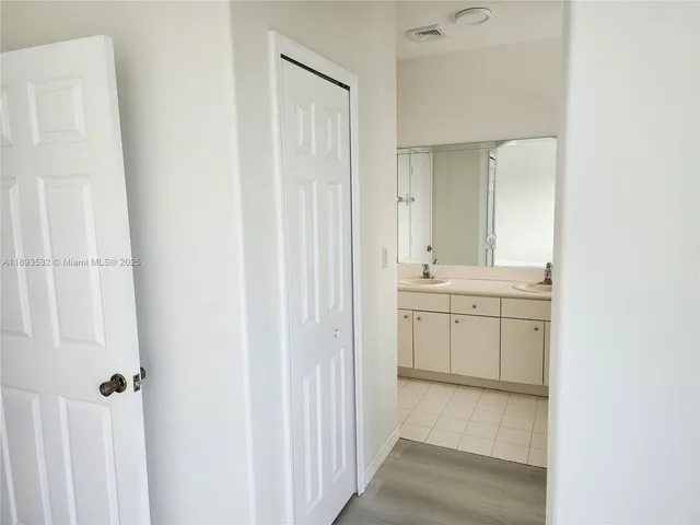 a bathroom with a sink a mirror and a bathtub