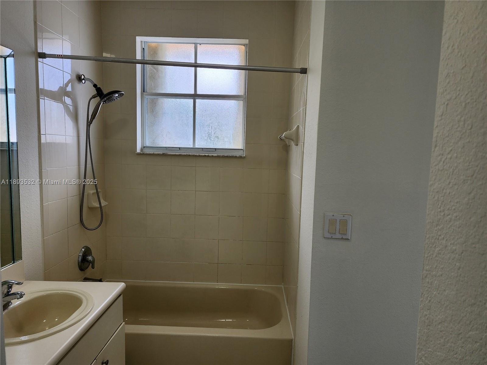 10831 Southwest 240th Lane Homestead, FL 33032 - Photo 24 of 33 a bathroom with a sink a mirror and a bathtub
