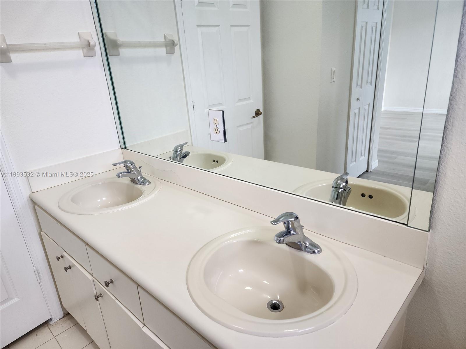10831 Southwest 240th Lane Homestead, FL 33032 - Photo 25 of 33 a bathroom with a sink and a mirror