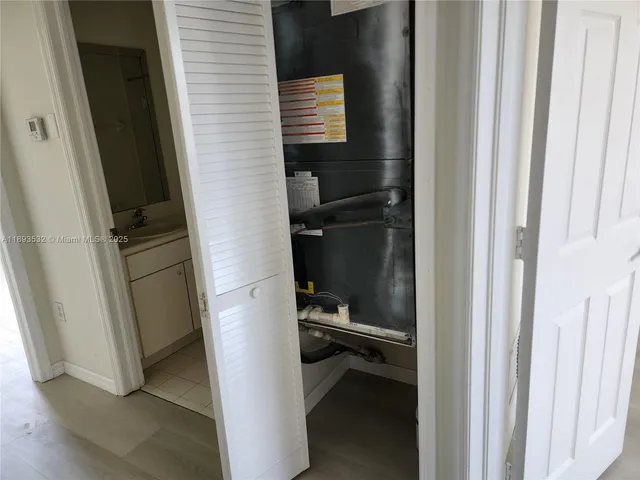 a view of walk in closet with empty racks