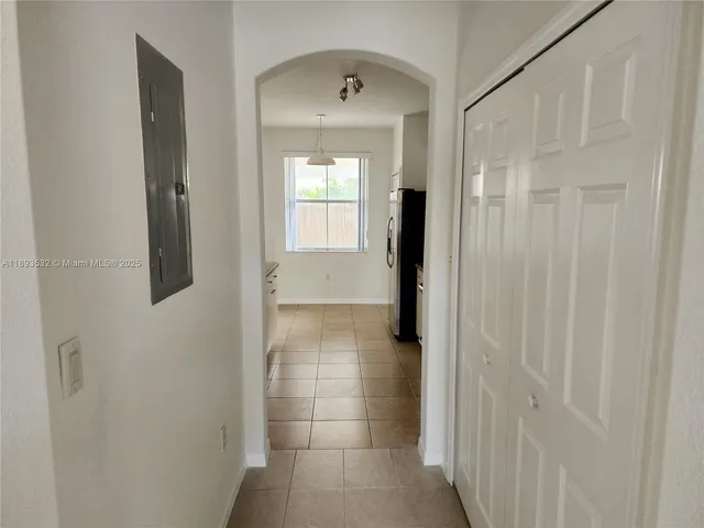 a kitchen with granite countertop a refrigerator and a stove top oven